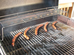Grilling sausage on a gas grill. Cook sausage on a gas grill